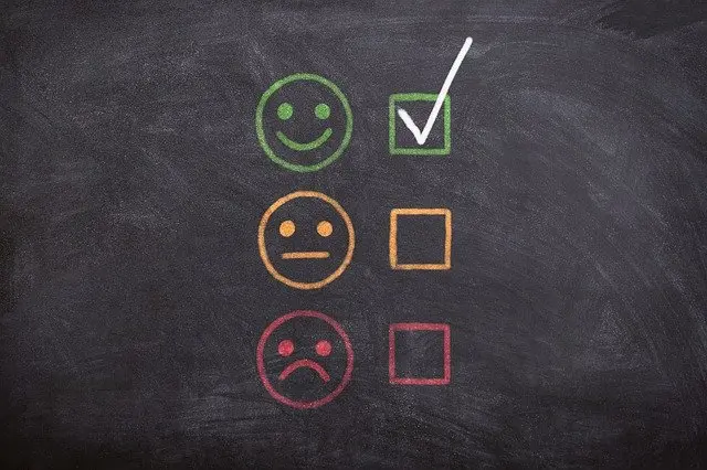 a chalkboard with happy, ambivalent, and sad faces. There is a green check next to the happy face chalkboard image by @athree23 from Pixabay