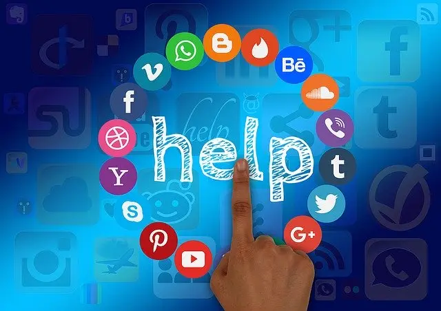 The word help surrounded by social media icons. A hand is tapping help like it is a button, desperate for help with the overwhelming nature of social media. Image by Gerd Altmann via Pixabay